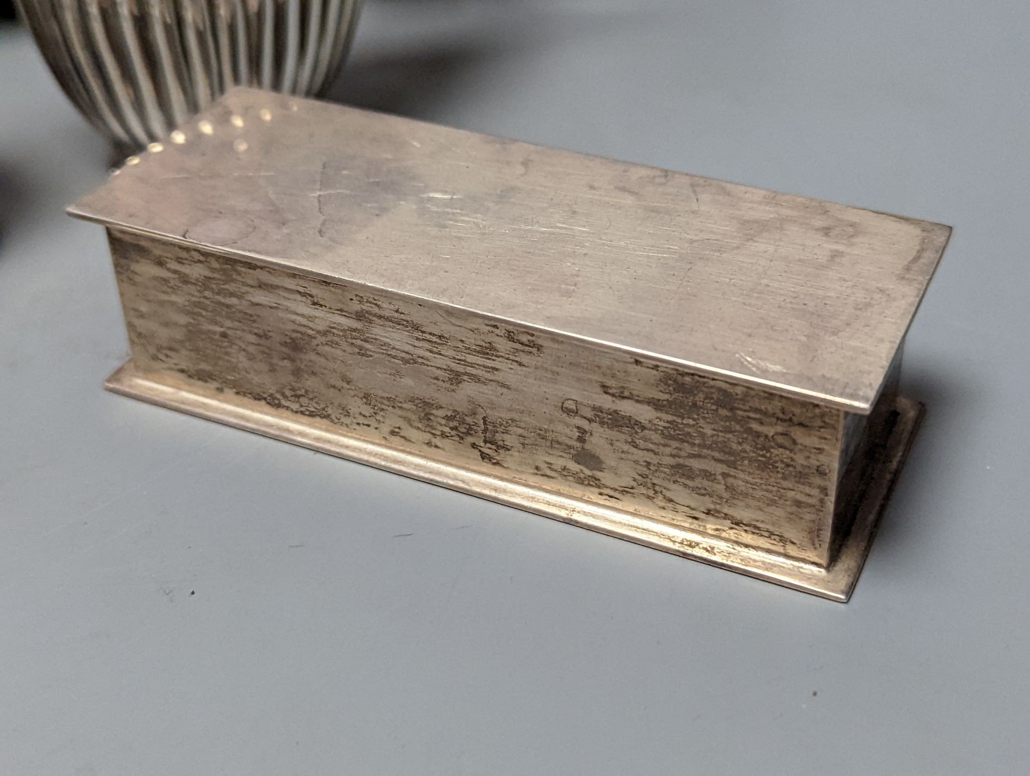 A group of assorted silver items including George V silver mounted hip flask(bruise), a pair of silver sauceboats(a.f.) one other sauceboat, sterling box, two silver cream jugs, cigarette box, salt, sugar tongs, brush an